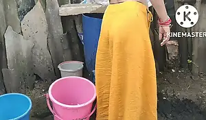 Indian house wife wash up outside