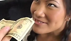 Petite Asian sucks massive dick and rides on the same plane for money