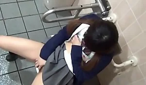 Japanese teen in uniform fingers her pussy