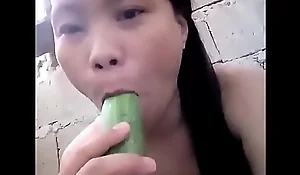 Oriental masturbating with cucumber